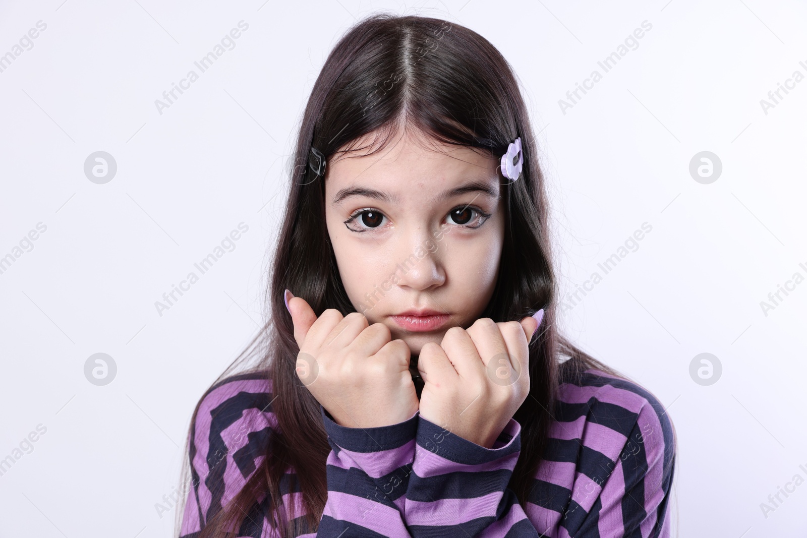 Photo of Teenage girl in stylish clothes and accessories posing on white background. Makeup in anime style