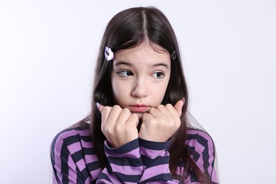 Photo of Teenage girl in stylish clothes and accessories posing on white background. Makeup in anime style