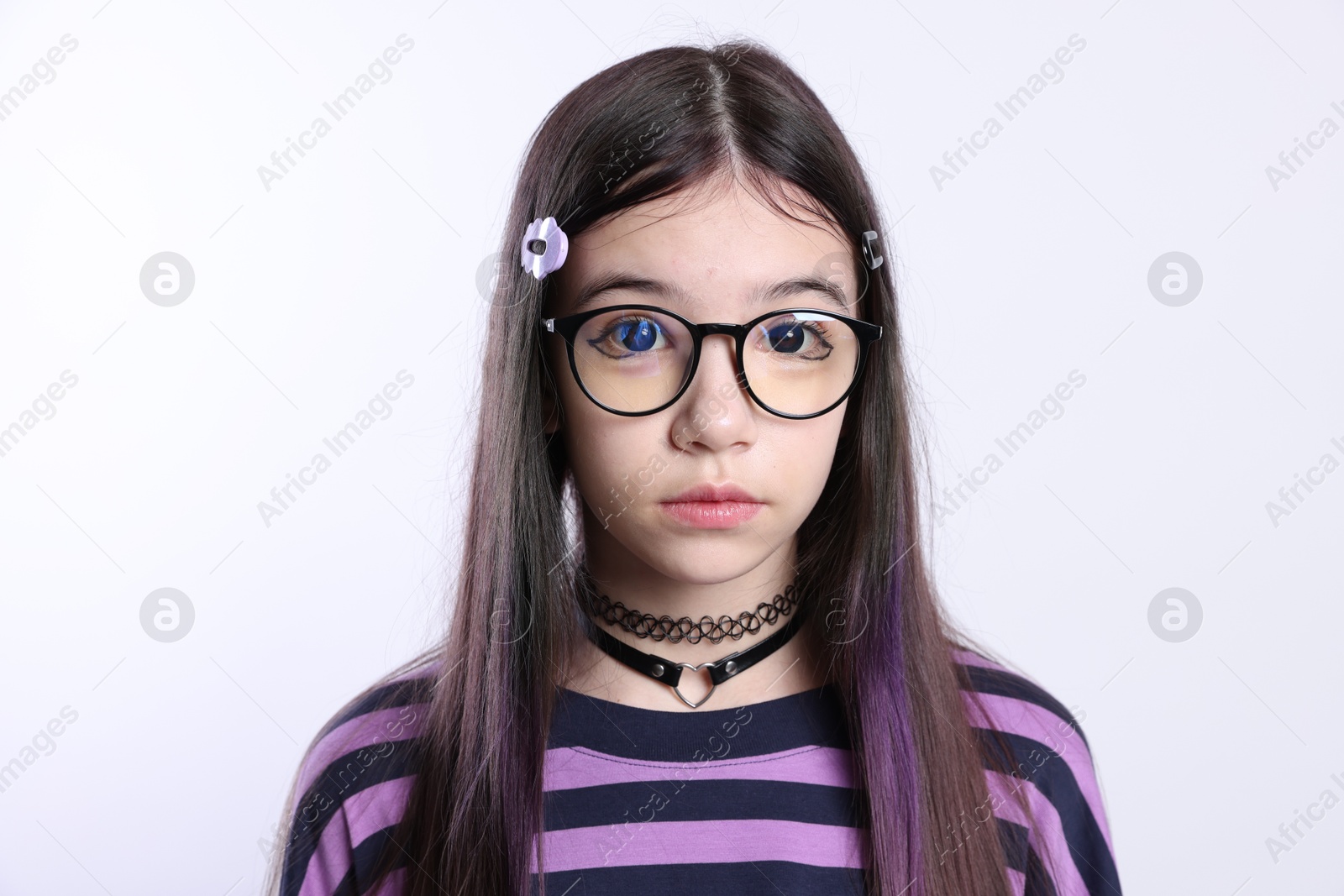 Photo of Teenage girl in stylish clothes and glasses posing on white background. Makeup in anime style