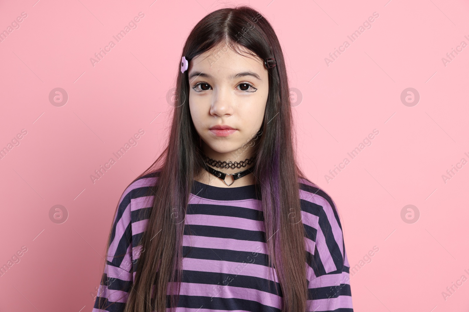 Photo of Teenage girl in stylish clothes posing on pink background. Makeup in anime style