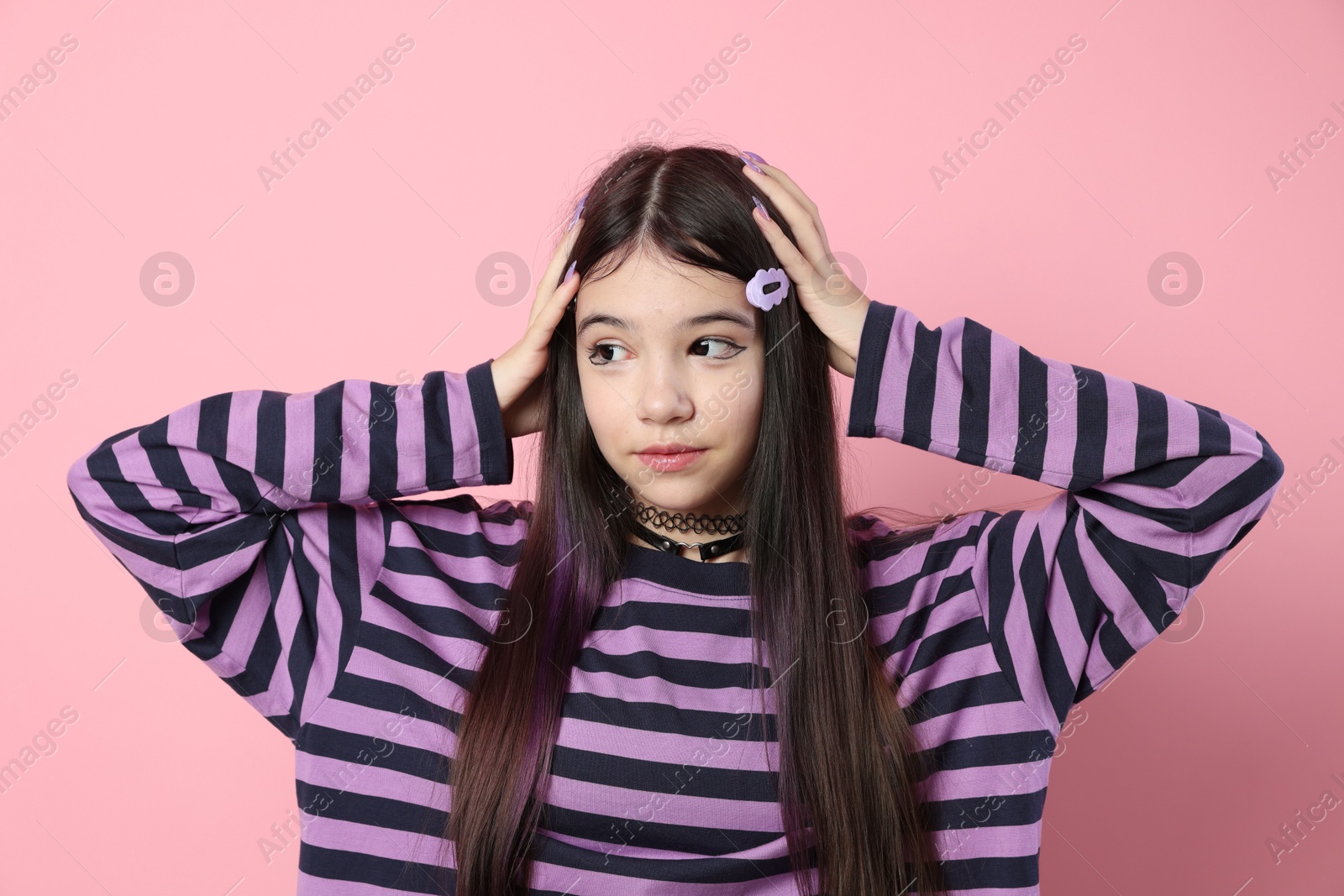 Photo of Teenage girl in stylish clothes posing on pink background. Makeup in anime style