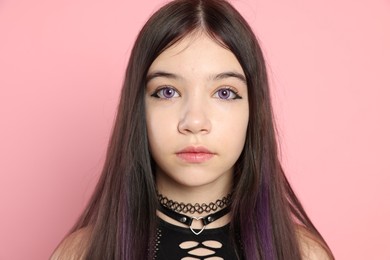 Photo of Teenage girl posing on pink background. Makeup and clothes in anime style