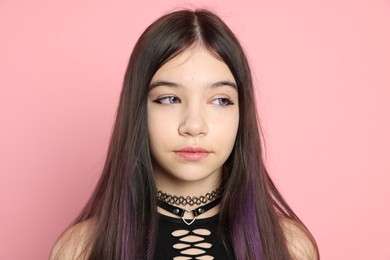 Photo of Teenage girl posing on pink background. Makeup and clothes in anime style