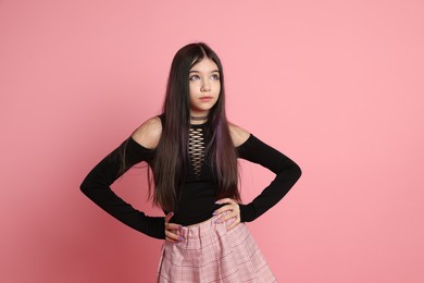 Teenage girl posing on pink background. Makeup and clothes in anime style