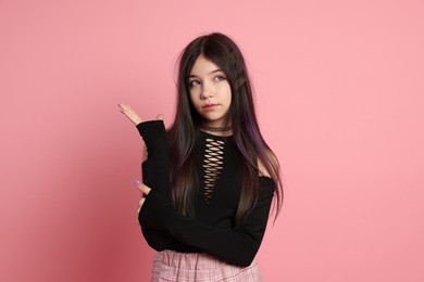 Teenage girl posing on pink background. Makeup and clothes in anime style