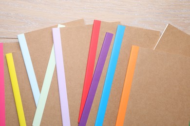 Photo of Different copybooks on wooden table, flat lay