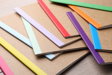 Photo of Many different copybooks on wooden table, closeup