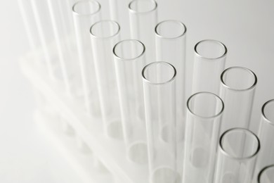 Empty test tubes on light background, closeup. Laboratory glassware