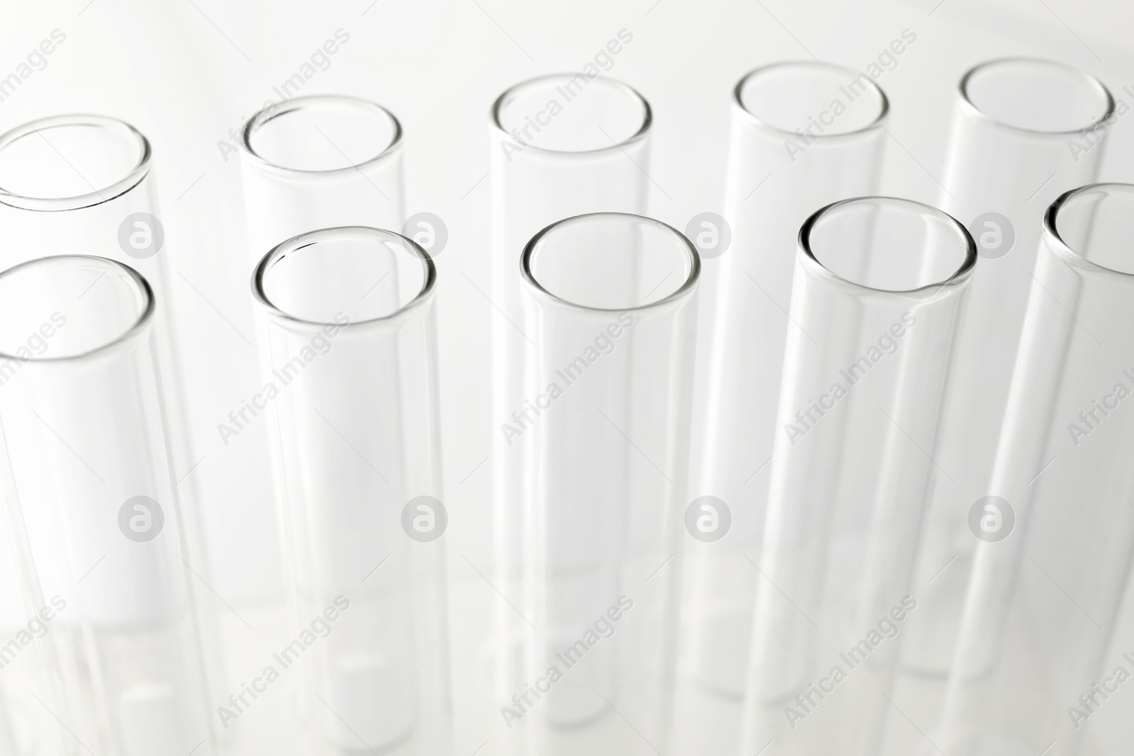 Photo of Empty test tubes on light background, closeup. Laboratory glassware