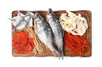 Many different dried fish snacks isolated on white, top view