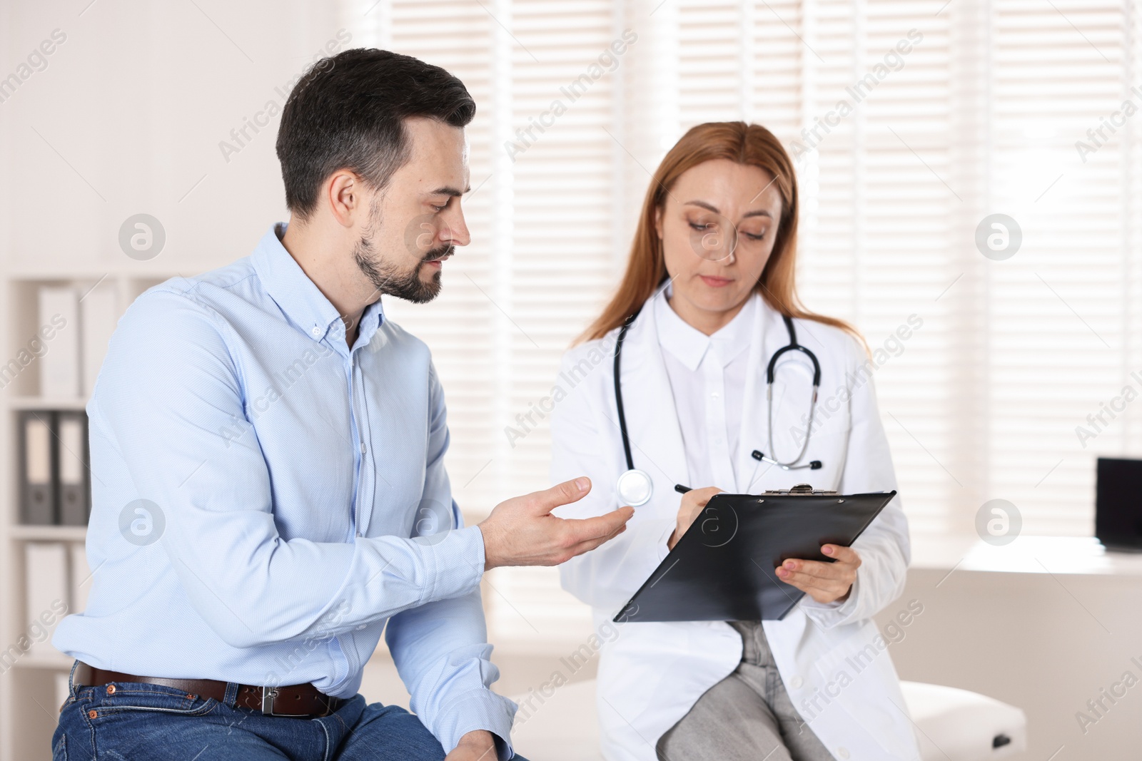 Photo of Man having appointment with cardiologist in clinic