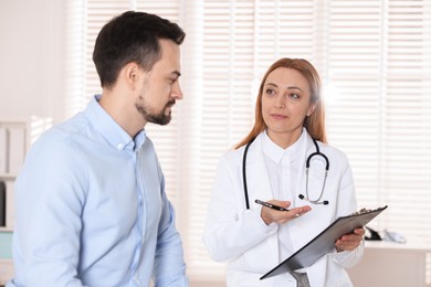 Photo of Man having appointment with cardiologist in clinic