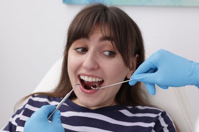 Scared woman having appointment with dentist in clinic