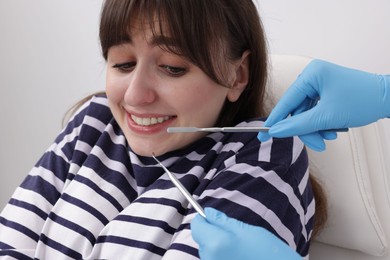 Photo of Scared woman having appointment with dentist in clinic