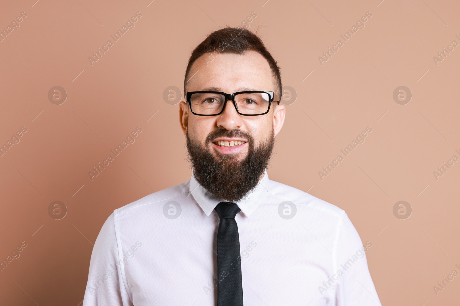 Photo of Handsome bearded man in formal outfit on brown background