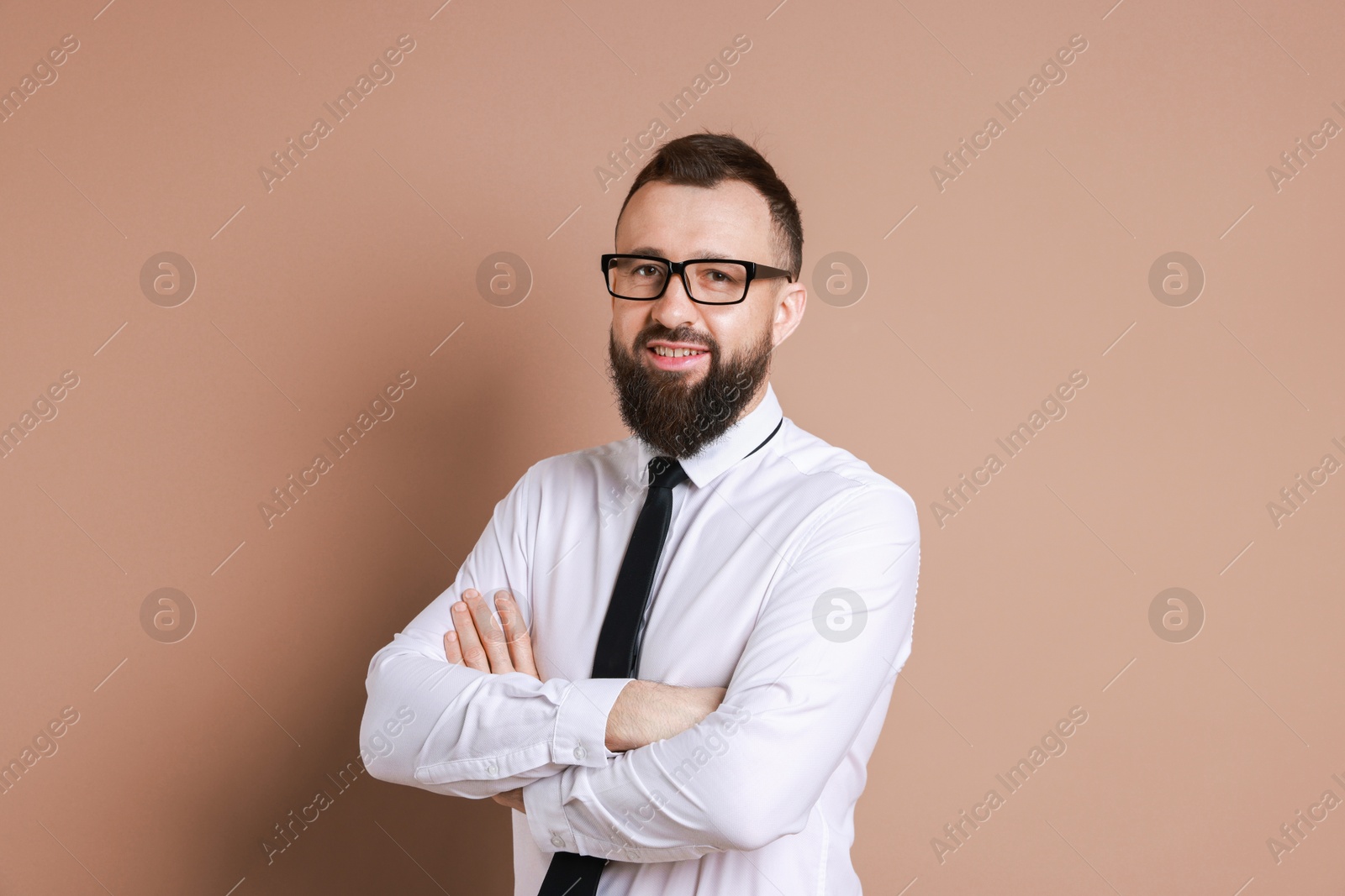 Photo of Handsome bearded man in formal outfit on brown background