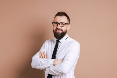 Handsome bearded man in formal outfit on brown background