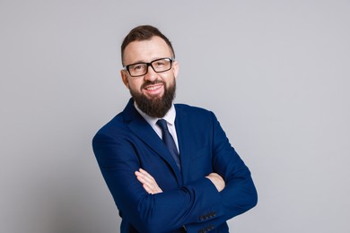 Photo of Handsome bearded man in suit on grey background