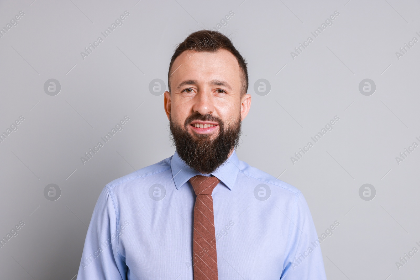 Photo of Handsome bearded man in formal outfit on grey background