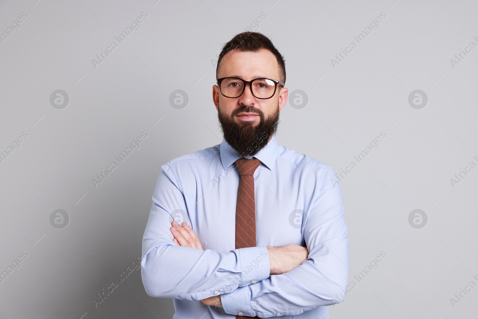 Photo of Handsome bearded man in formal outfit on grey background