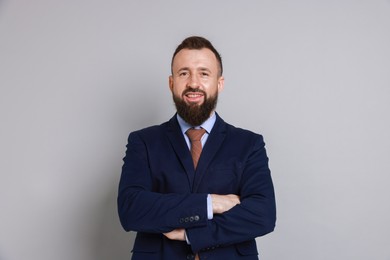 Photo of Handsome bearded man in suit on grey background