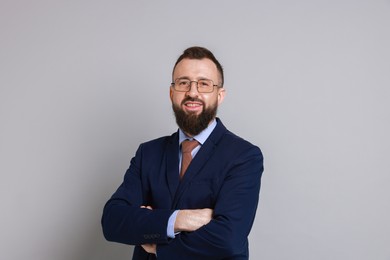 Handsome bearded man in suit on grey background