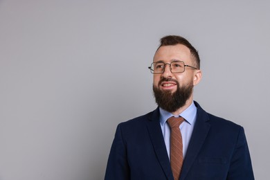 Photo of Handsome bearded man in suit on grey background. Space for text