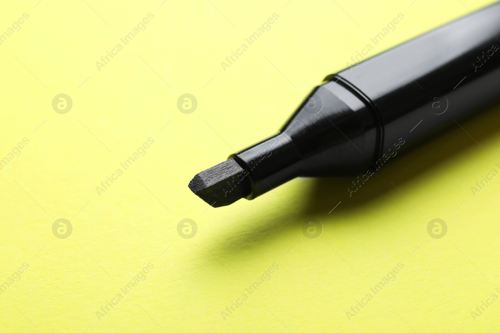 Photo of One color marker on yellow background, closeup. Space for text