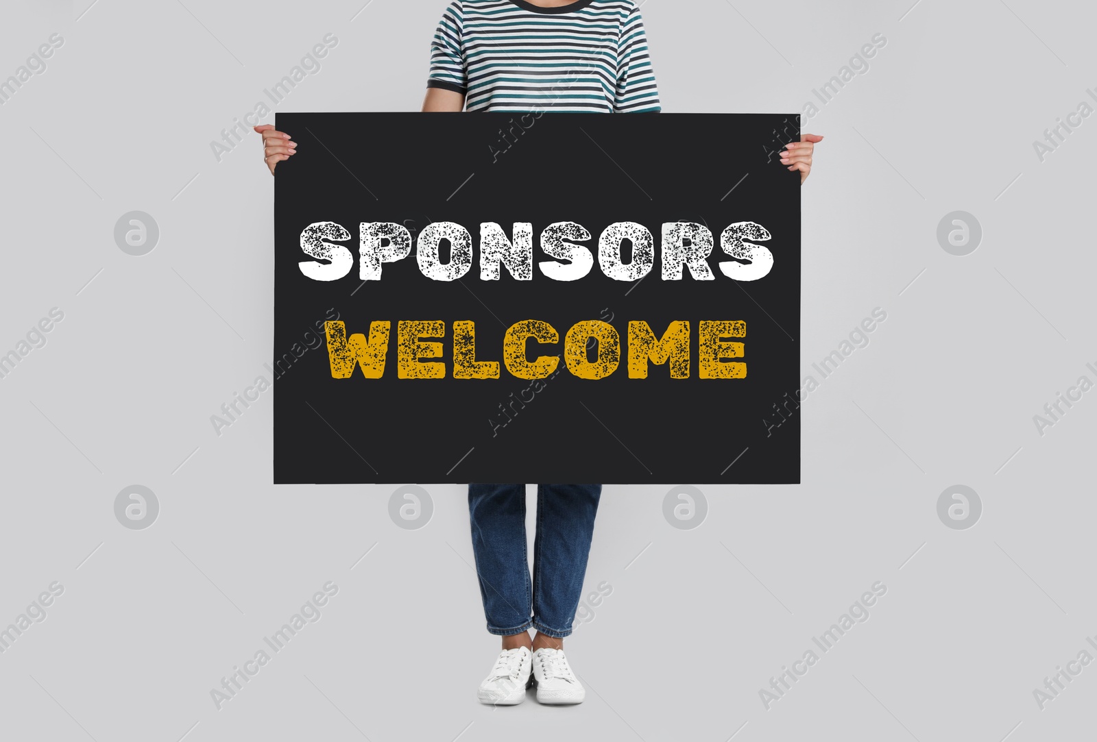 Image of Woman holding black poster with text Sponsors Welcome on light background, closeup