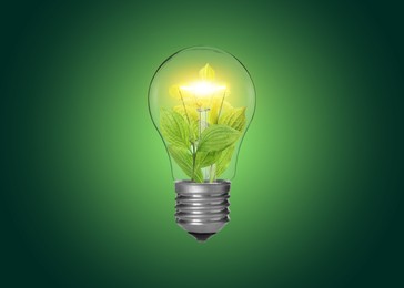 Image of Light bulb with fresh leaves inside in air on green gradient background. Concepts of eco-friendly environment and saving energy