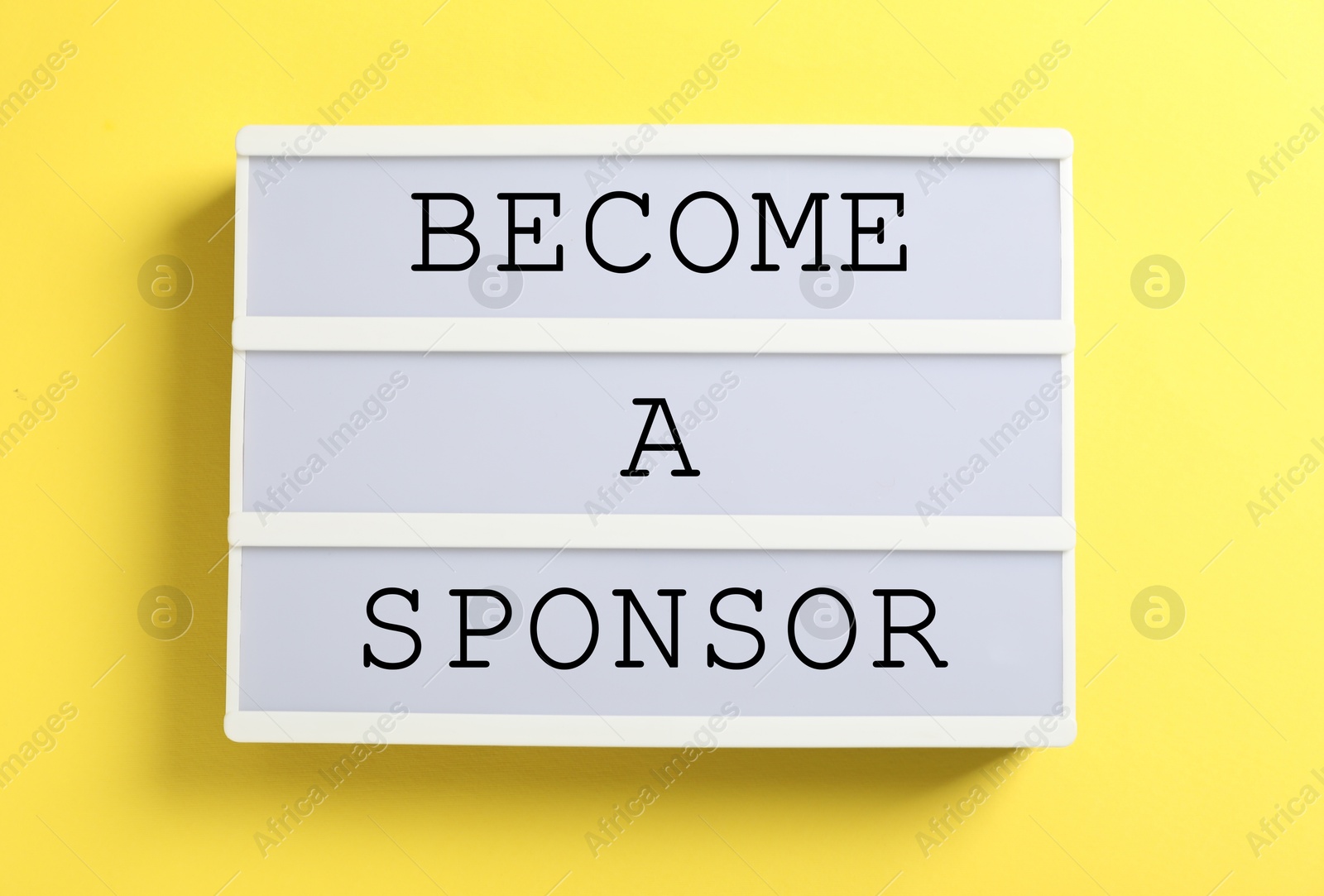 Image of Letter board with text Become A Sponsor on yellow background