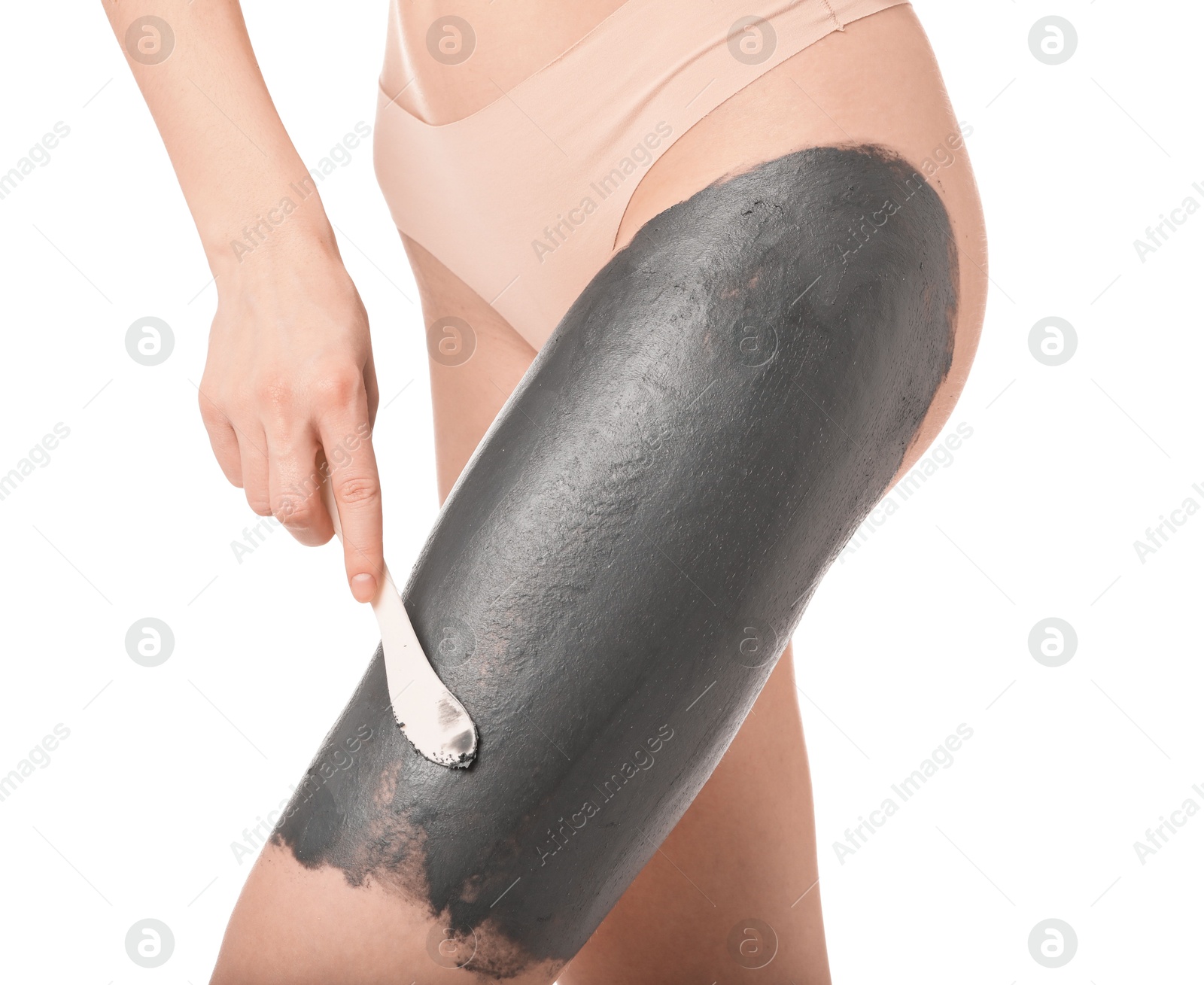 Photo of Woman applying cosmetic product for spa body wraps onto her leg against white background, closeup