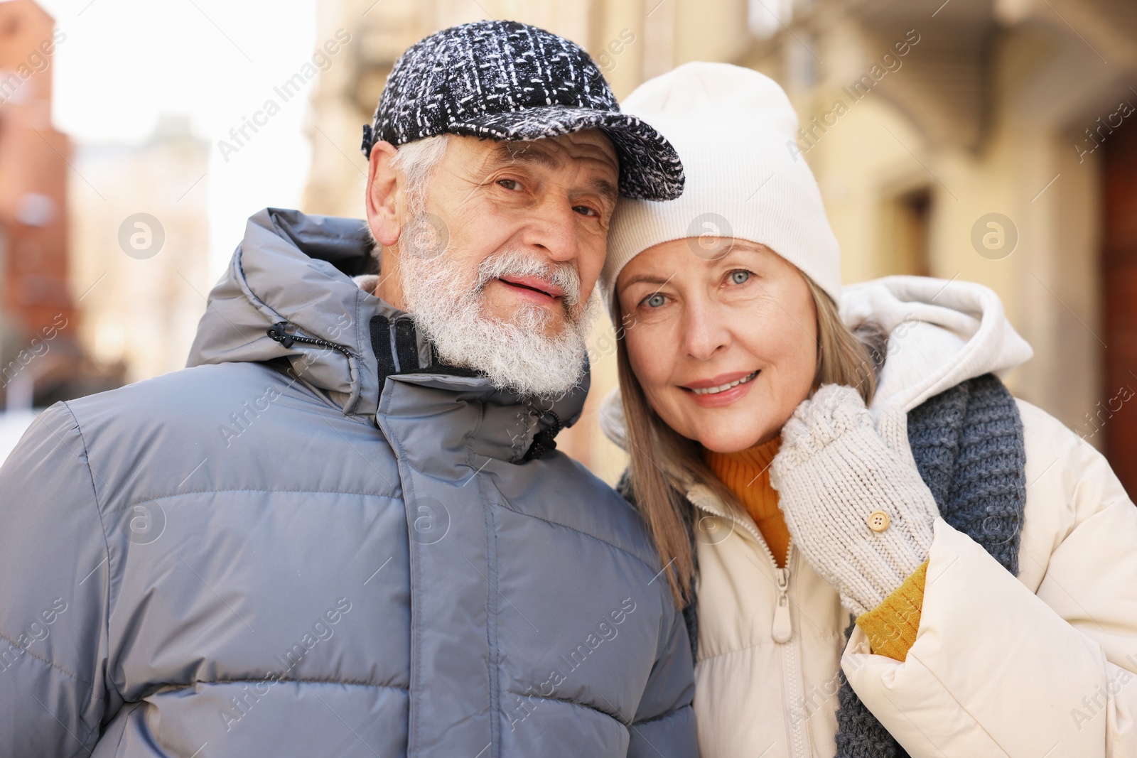 Family portrait of happy elderly couple on city street Photo of Family portrait of happy elderly couple on city street