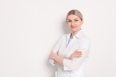 Photo of Portrait of professional dentist on white background. Space for text