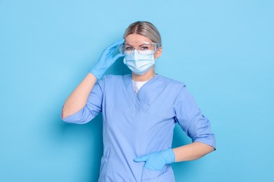 Portrait of professional dentist on light blue background