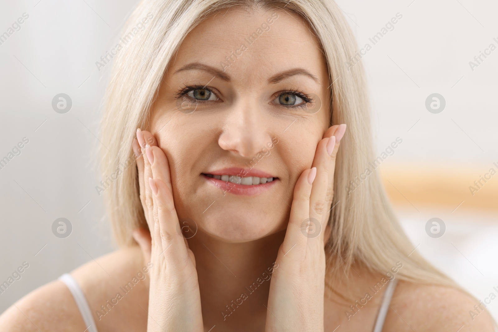 Photo of Portrait of beautiful woman with blonde hair indoors