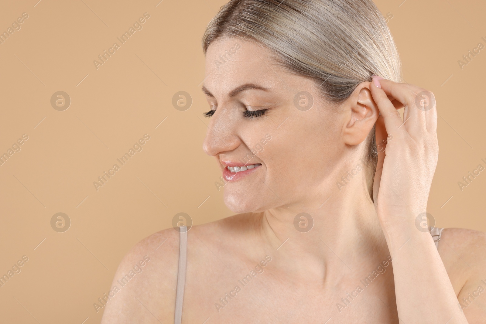 Photo of Portrait of beautiful woman on beige background