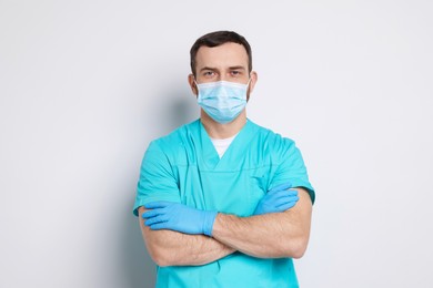 Portrait of professional dentist on light background