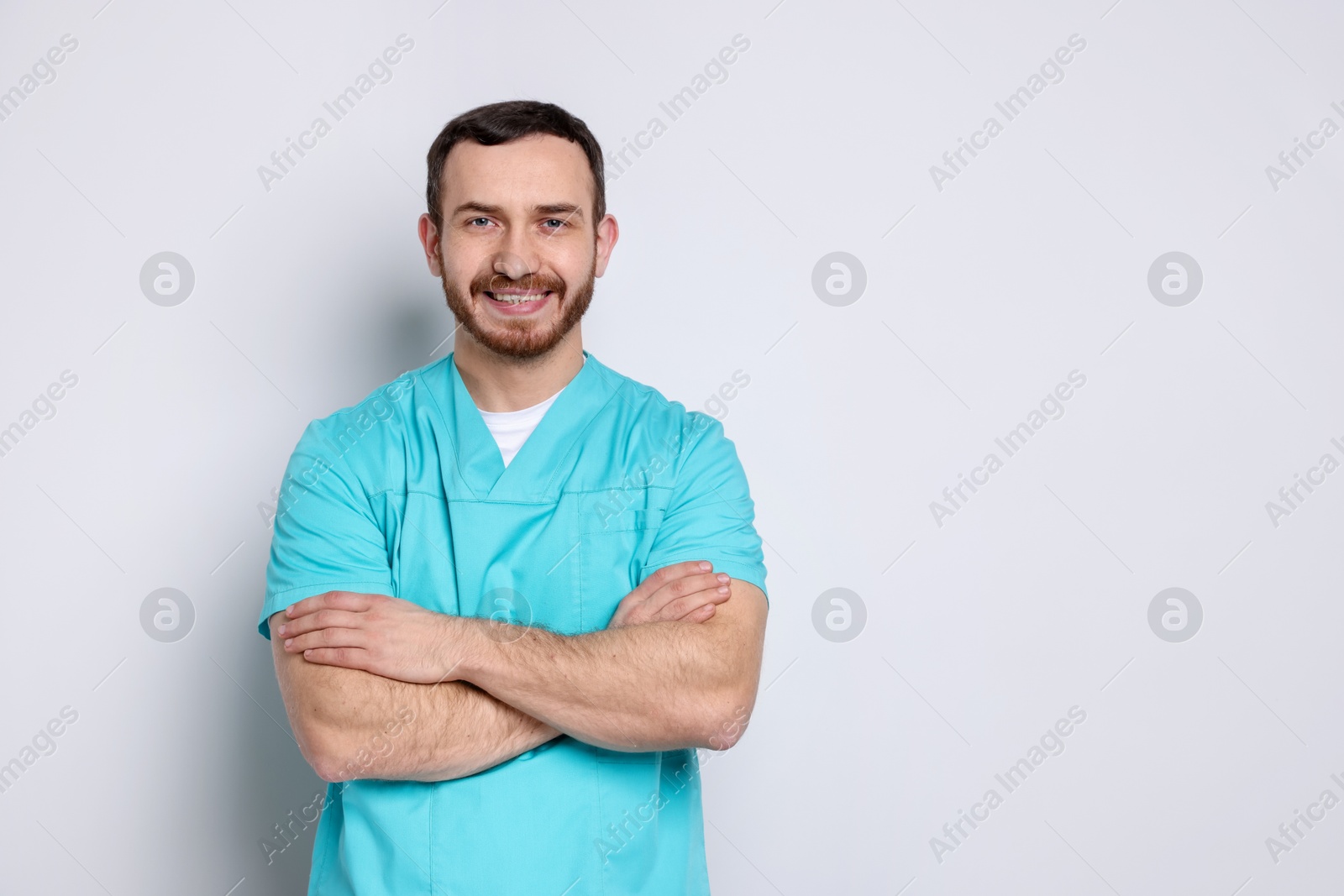 Photo of Portrait of professional dentist on light background. Space for text