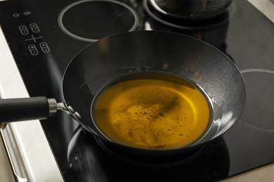 Photo of Used cooking oil in frying pan on stove in kitchen