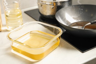 Photo of Used cooking oil in kitchen, closeup view