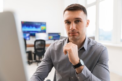 Financial trading specialist working on computer in office