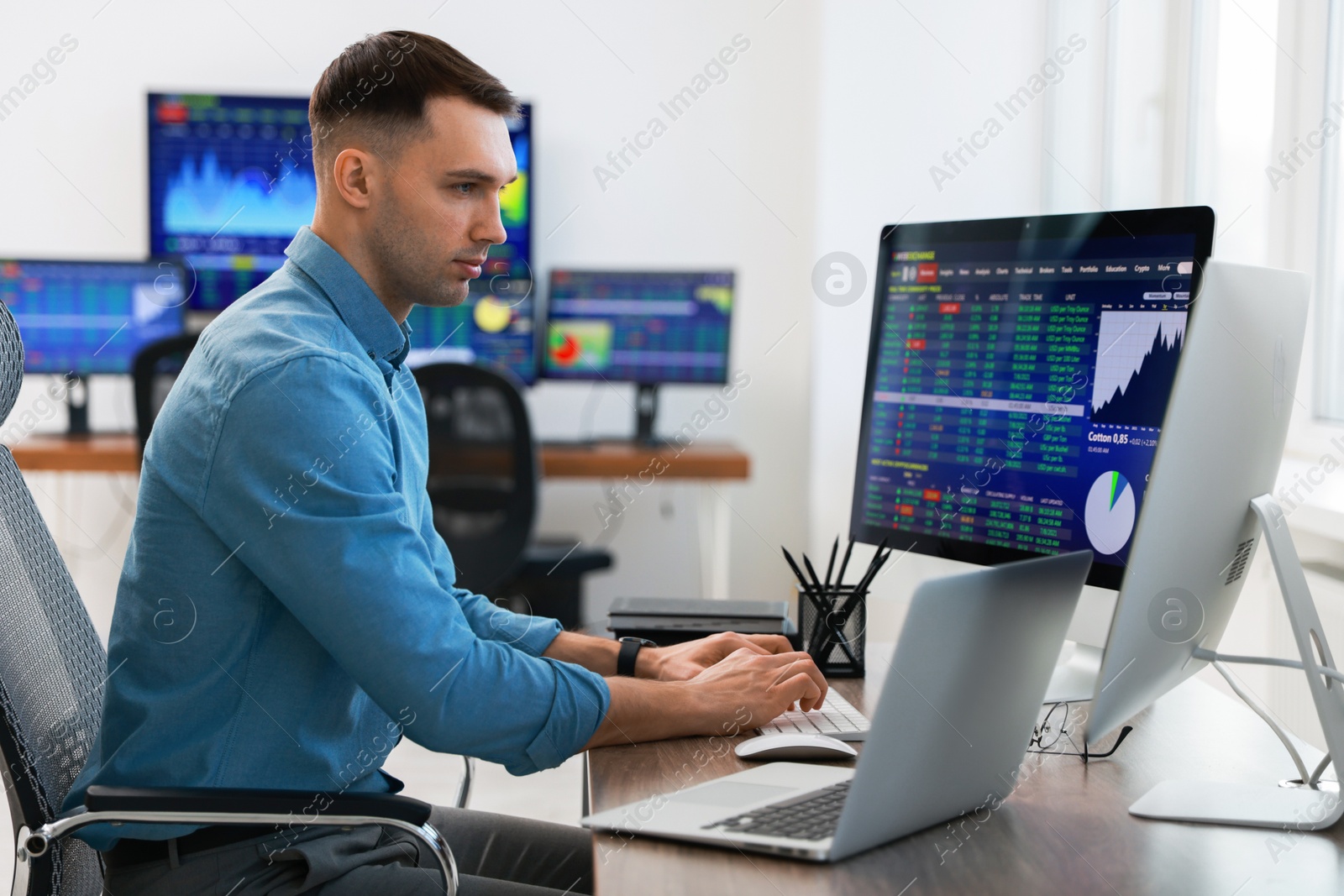 Photo of Financial trading specialist working on computer in office