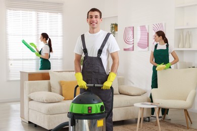 Professional cleaning service team working in room