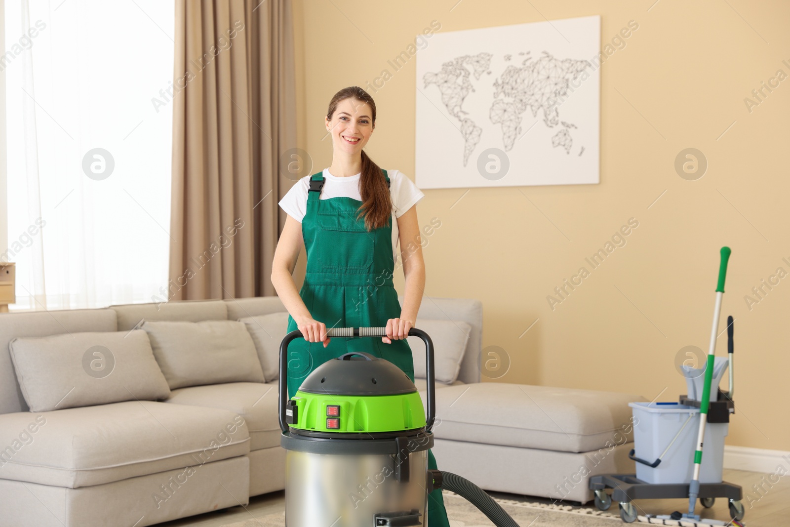 Photo of Cleaning service worker with professional hoover indoors