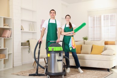 Cleaning service workers with equipment in room