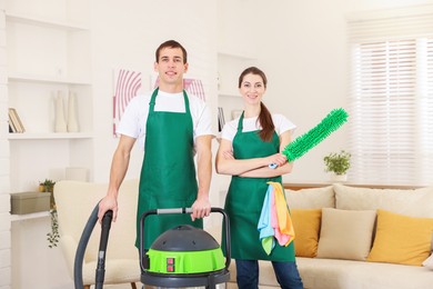 Cleaning service workers with equipment in room