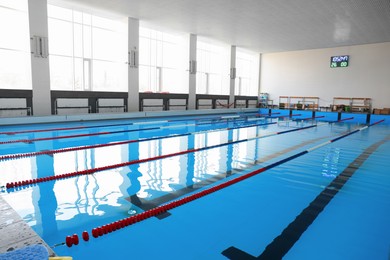 Photo of Swimming pool with clean water and lane dividers indoors