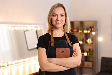 Photo of Portrait of smiling hairdresser in beauty salon