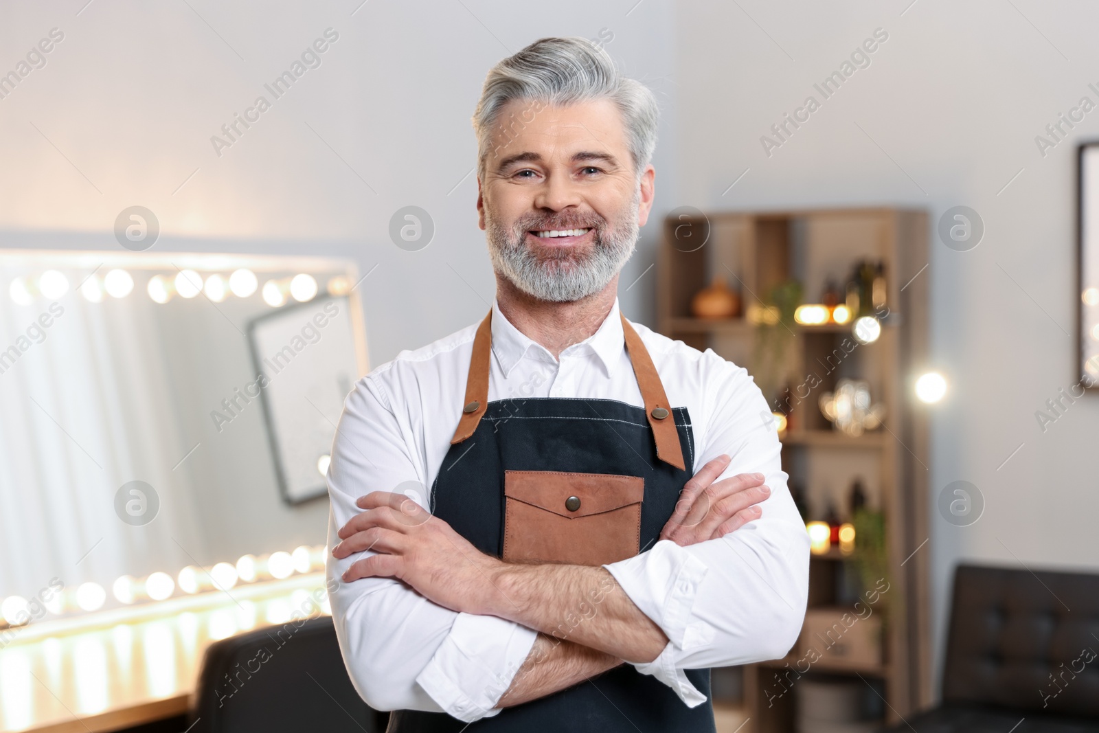 Photo of Portrait of smiling hairdresser in beauty salon